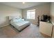 Carpeted bedroom with a window, computer desk, and a comfortable bed at 9648 Spyglass Run Ave, Las Vegas, NV 89178