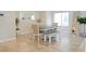 Bright dining room features a modern table with bench seating, complemented by stylish decor and tiled flooring at 9648 Spyglass Run Ave, Las Vegas, NV 89178