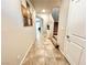 Inviting hallway featuring neutral paint and tile floors leading to an upstairs staircase at 9648 Spyglass Run Ave, Las Vegas, NV 89178
