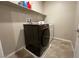Laundry room featuring modern front-load washer and dryer at 9648 Spyglass Run Ave, Las Vegas, NV 89178