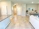Open-concept living space with tile flooring flowing from the entry and kitchen to the dining area at 9648 Spyglass Run Ave, Las Vegas, NV 89178