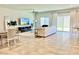 Bright living room with tile floors, backyard views, ceiling fan and comfortable seating at 9648 Spyglass Run Ave, Las Vegas, NV 89178