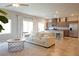 Open-concept living area with a comfortable sofa and adjacent kitchen offers a seamless living experience at 9648 Spyglass Run Ave, Las Vegas, NV 89178