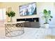 Stylish living room featuring a modern entertainment center, decorative plants, and a chic coffee table at 9648 Spyglass Run Ave, Las Vegas, NV 89178