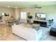 Open-concept living area with modern furniture, TV, and dining space creates an inviting atmosphere at 9648 Spyglass Run Ave, Las Vegas, NV 89178