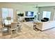 Open living room with tile flooring, adjacent to a dining area and modern furniture at 9648 Spyglass Run Ave, Las Vegas, NV 89178