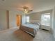 Spacious primary bedroom with neutral carpet, a ceiling fan, and an ensuite bathroom at 9648 Spyglass Run Ave, Las Vegas, NV 89178