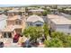 Aerial view of a home with a neatly landscaped front yard, complemented by mature trees at 10164 Village Breeze Pl, Las Vegas, NV 89183