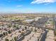 Aerial view showcasing a well-planned community with solar-equipped homes near schools and commercial areas at 10164 Village Breeze Pl, Las Vegas, NV 89183