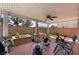 Covered back patio with a ceiling fan, outdoor seating, and a BBQ grill for entertaining at 10164 Village Breeze Pl, Las Vegas, NV 89183
