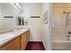Bright bathroom featuring a double sink vanity, mirror, and shower/bathtub at 10164 Village Breeze Pl, Las Vegas, NV 89183
