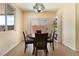 Dining room featuring a modern light fixture, a shelf and a sliding glass door with access to the backyard at 10164 Village Breeze Pl, Las Vegas, NV 89183