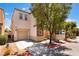 Charming two-story home featuring a garage and a well-maintained front yard with gravel and a sidewalk at 10164 Village Breeze Pl, Las Vegas, NV 89183