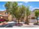Charming two-story home featuring a garage, a well-maintained front yard and a sidewalk at 10164 Village Breeze Pl, Las Vegas, NV 89183