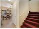 Hallway view leading to a dining area and a carpeted staircase at 10164 Village Breeze Pl, Las Vegas, NV 89183