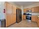 Functional kitchen featuring stainless steel appliances, wooden cabinets and lots of storage space at 10164 Village Breeze Pl, Las Vegas, NV 89183