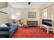 Bright living room featuring blinds, carpet flooring, and natural light at 10164 Village Breeze Pl, Las Vegas, NV 89183