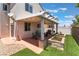 Outdoor patio area featuring a covered pergola, string lights, planters, and a grill, perfect for entertaining at 10164 Village Breeze Pl, Las Vegas, NV 89183