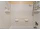 Shower/bathtub with white tile, adjustable shower head, and corner caddy at 10164 Village Breeze Pl, Las Vegas, NV 89183