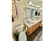 Bathroom featuring double sinks, wood cabinets, and updated fixtures at 10500 Horseshoe Falls Ct, Las Vegas, NV 89144