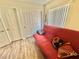 Cozy bedroom with a red futon and pillows with bright natural light at 10500 Horseshoe Falls Ct, Las Vegas, NV 89144