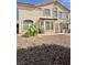 Exterior view of the home showcasing the desert landscape and patio at 10500 Horseshoe Falls Ct, Las Vegas, NV 89144