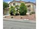 Two-story home featuring a well-kept lawn, mature trees, and paved driveway at 10500 Horseshoe Falls Ct, Las Vegas, NV 89144