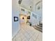Open concept foyer with tiled floors and staircase with glass railing at 10500 Horseshoe Falls Ct, Las Vegas, NV 89144