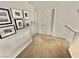 Second floor hallway with carpet and picture frames on the wall at 10500 Horseshoe Falls Ct, Las Vegas, NV 89144
