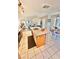 Bright open kitchen featuring an island, tile flooring, and a view of the living room at 10500 Horseshoe Falls Ct, Las Vegas, NV 89144