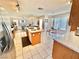 Kitchen island with double sink with seating leads to dining area and living room at 10500 Horseshoe Falls Ct, Las Vegas, NV 89144