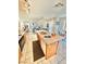 Kitchen island featuring granite countertops, a sink, and views into the living area at 10500 Horseshoe Falls Ct, Las Vegas, NV 89144