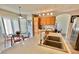 Bright kitchen featuring an island with a sink, wooden cabinetry, and a casual eat-in dining area at 10500 Horseshoe Falls Ct, Las Vegas, NV 89144