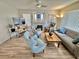 Living room with a fireplace, lots of light from windows, and wood laminate flooring throughout at 10500 Horseshoe Falls Ct, Las Vegas, NV 89144