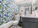 Stylish bathroom with a leaf patterned shower curtain and gray vanity at 110 Eagleview Ct, Henderson, NV 89074