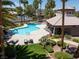 Community pool area featuring a unique pool shape, lounge chairs, and desert landscaping, with a covered seating area at 110 Eagleview Ct, Henderson, NV 89074