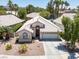 Exterior elevation showcasing a single-story home with desert landscaping, a two-car garage and tile roof at 110 Eagleview Ct, Henderson, NV 89074