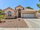 Single-story home featuring desert landscaping, a tile roof, and an attached two-car garage at 110 Eagleview Ct, Henderson, NV 89074