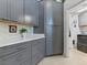 Modern kitchen featuring sleek gray cabinets, white countertops, and mosaic tile backsplash at 110 Eagleview Ct, Henderson, NV 89074