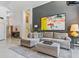Comfortable living room featuring a sectional sofa and modern artwork at 110 Eagleview Ct, Henderson, NV 89074