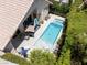 Overhead shot of a stunning pool with hot tub, manicured landscaping, and a patio with dining furniture at 110 Eagleview Ct, Henderson, NV 89074