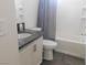 Bright bathroom featuring a vanity with granite countertop and a shower over tub with tile surround at 11173 Hickory Glen St, Las Vegas, NV 89179