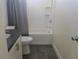 A bathroom with gray walls, a white toilet and white tub at 11173 Hickory Glen St, Las Vegas, NV 89179