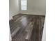 An empty room with wood-look flooring and a window with white blinds at 11173 Hickory Glen St, Las Vegas, NV 89179