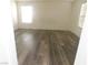 Bedroom with wood-look floors, neutral paint, and natural light from two windows at 11173 Hickory Glen St, Las Vegas, NV 89179