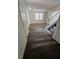 Entryway featuring gray wood-look flooring, and staircase with white railing at 11173 Hickory Glen St, Las Vegas, NV 89179
