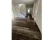 Living room with wood-look floors, a staircase, and plenty of natural light at 11173 Hickory Glen St, Las Vegas, NV 89179