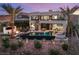 Aerial view of a modern home with a backyard pool, spa, fire pit, and a spiral staircase at 12 Desert Lake Ln, Henderson, NV 89011