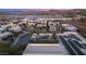 Community aerial view showcasing a rooftop deck, pool, and lake views near modern homes and solar panels at 12 Desert Lake Ln, Henderson, NV 89011