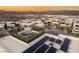 Aerial view of rooftops, community lake and modern home design with mountain views at 12 Desert Lake Ln, Henderson, NV 89011
